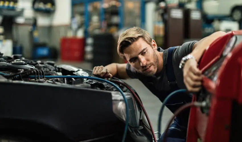 Car repair service at home in Dubai – mobile mechanic fixing car at customer’s driveway
